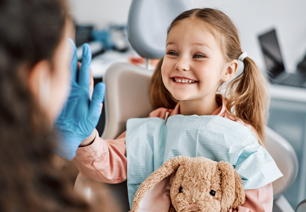 kid with teddy bear smiling